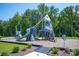 Fun community playground with slides and climbing features surrounded by lush greenery at 3607 Clover Valley Dr, Gastonia, NC 28052