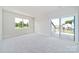 Spacious bedroom with neutral walls and floors, featuring a window and balcony access at 97 Seven Oaks Lndg, Belmont, NC 28012