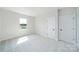 Bright bedroom featuring neutral walls, plush carpet, a window, and two doors at 97 Seven Oaks Lndg, Belmont, NC 28012