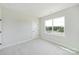 Bright, neutral bedroom features a window providing outdoor views and natural light at 97 Seven Oaks Lndg, Belmont, NC 28012