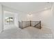 Bright hallway with carpet flooring, railing and balcony access for added outdoor enjoyment at 97 Seven Oaks Lndg, Belmont, NC 28012