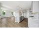 Bright kitchen with white cabinets, quartz countertops, stainless steel appliances, and a large center island at 97 Seven Oaks Lndg, Belmont, NC 28012
