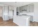 Modern kitchen featuring gray cabinets, white countertops, stainless appliances, and a central island with sink at 97 Seven Oaks Lndg, Belmont, NC 28012