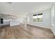 Open-concept living space showcasing hardwood floors, abundant natural light, and a kitchen with a center island at 97 Seven Oaks Lndg, Belmont, NC 28012