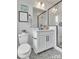 Modern bathroom features gray patterned tile floor and white cabinets at 1340 Hamilton St # 3, Charlotte, NC 28206