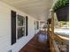 Inviting front porch with wooden railings and hanging plants at 225 York Ave, Kannapolis, NC 28083