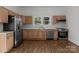 Modern kitchen with stainless steel appliances and wood cabinets at 225 York Ave, Kannapolis, NC 28083