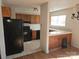 Kitchen with dark wood cabinets and black appliances at 3710 Burntwood Ct, Charlotte, NC 28227