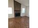 Living room featuring a brick fireplace and wood-look flooring at 3710 Burntwood Ct, Charlotte, NC 28227