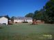 Spacious backyard featuring lush lawn, play set, and a wooden fence at 3905 Autumn Wood Dr # 28, Monroe, NC 28112