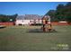 Large backyard with a playset and surrounded by a wooden fence at 3905 Autumn Wood Dr # 28, Monroe, NC 28112