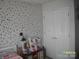 Bright bedroom features playful decor and closet at 3905 Autumn Wood Dr # 28, Monroe, NC 28112