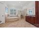 Luxurious bathroom with soaking tub, walk-in shower, and double vanity at 5942 Carmel Rd, Charlotte, NC 28226