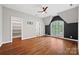 Bright bedroom with hardwood floors, built-in shelves, and a ceiling fan at 5942 Carmel Rd, Charlotte, NC 28226