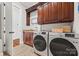 Bright laundry room, features washer, dryer, cabinets, and countertop at 5942 Carmel Rd, Charlotte, NC 28226