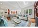 Open living room with light-colored sofas and a view into the kitchen at 5942 Carmel Rd, Charlotte, NC 28226