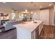 Modern kitchen island with sink and seating overlooking living room at 621 Seldon Dr, Charlotte, NC 28216