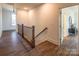 Upstairs hallway with dark hardwood floors and iron railing at 621 Seldon Dr, Charlotte, NC 28216