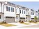Charming townhouse exteriors with modern design, garages, and well-manicured lawns at 3016 Endhaven Terraces Ln # 11, Charlotte, NC 28277