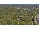 Aerial view shows home nestled in wooded lot, near residential area at 9016 Kensington Dr, Waxhaw, NC 28173