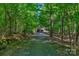 Long driveway leading to a home nestled in the woods at 9016 Kensington Dr, Waxhaw, NC 28173