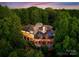 Stunning aerial view of luxury home, surrounded by lush trees and beautiful architectural design at 10310 Wildlife Rd, Charlotte, NC 28278