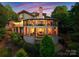 Stunning architectural home back view with a multi-level deck and lush landscaping, creating an amazing outdoor living at 10310 Wildlife Rd, Charlotte, NC 28278