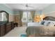 Bedroom featuring a large window with patterned drapes, wooden dresser and queen bed at 10310 Wildlife Rd, Charlotte, NC 28278