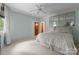 Bedroom with natural light, a ceiling fan, and an decorative mirrored headboard at 10310 Wildlife Rd, Charlotte, NC 28278