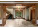 Grand foyer with detailed woodwork, stone floors, and ornate glass front doors at 10310 Wildlife Rd, Charlotte, NC 28278