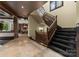 Grand foyer features a staircase with wood banister, natural light, and access to the kitchen at 10310 Wildlife Rd, Charlotte, NC 28278