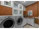 Functional laundry room with sink, countertop, and side-by-side washer and dryer at 10310 Wildlife Rd, Charlotte, NC 28278