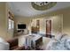 Living room with natural light, modern furniture, and staircase in the background at 10310 Wildlife Rd, Charlotte, NC 28278