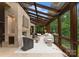 Bright and airy living room featuring a fireplace, seating, and glass ceiling with wooded views at 10310 Wildlife Rd, Charlotte, NC 28278
