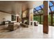 Sunlit living room with stone fireplace, tile floors, and floor-to-ceiling windows with view at 10310 Wildlife Rd, Charlotte, NC 28278