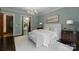 A luxury main bedroom with elegant chandelier, sitting area, and view to an ensuite space at 10310 Wildlife Rd, Charlotte, NC 28278