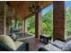 Relaxing covered patio with a hot tub and stone features, offering an idyllic space for outdoor enjoyment at 10310 Wildlife Rd, Charlotte, NC 28278