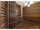 Beautifully designed wine cellar with custom wooden racks and tile accent wall providing an elegant storage space at 10310 Wildlife Rd, Charlotte, NC 28278