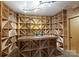 Well-organized wine cellar with geometric wooden racks and a counter space, perfect for wine enthusiasts at 10310 Wildlife Rd, Charlotte, NC 28278