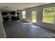 Open concept living space with dark cabinets, stainless appliances, gray floors and natural light at 1313 Dodd St, Shelby, NC 28152