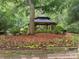 Wooden gazebo nestled in a lush green garden setting at 12009 Matthew Martin Ln, Charlotte, NC 28216