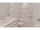 Bathroom featuring a tub, toilet, and single sink with a modern faucet and minimalist design at 222 Gilead Rd, Huntersville, NC 28078