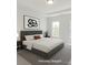 This modern bedroom features neutral tones, recessed lighting, and large windows at 222 Gilead Rd, Huntersville, NC 28078