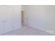 Clean bedroom with neutral carpet and a closet with double doors leading to a hallway at 222 Gilead Rd, Huntersville, NC 28078