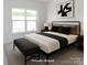 Bright modern bedroom features black accents, recessed lighting, and large windows at 222 Gilead Rd, Huntersville, NC 28078