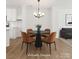 Dining room features modern table set, chandelier, and virtually staged decor at 222 Gilead Rd, Huntersville, NC 28078