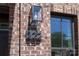 Close up of the exterior with brick facade, a black-trimmed window, and house number 222 at 222 Gilead Rd, Huntersville, NC 28078