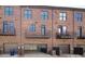 Brick townhome featuring a rear-entry two-car garage and upper-level balconies at 222 Gilead Rd, Huntersville, NC 28078
