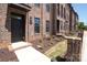 A brick townhome with a covered entry and landscaped front yard showcasing attractive curb appeal at 222 Gilead Rd, Huntersville, NC 28078