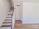 Hallway with wood-look floors, stairs, and a neutral color scheme that feels spacious and inviting at 222 Gilead Rd, Huntersville, NC 28078